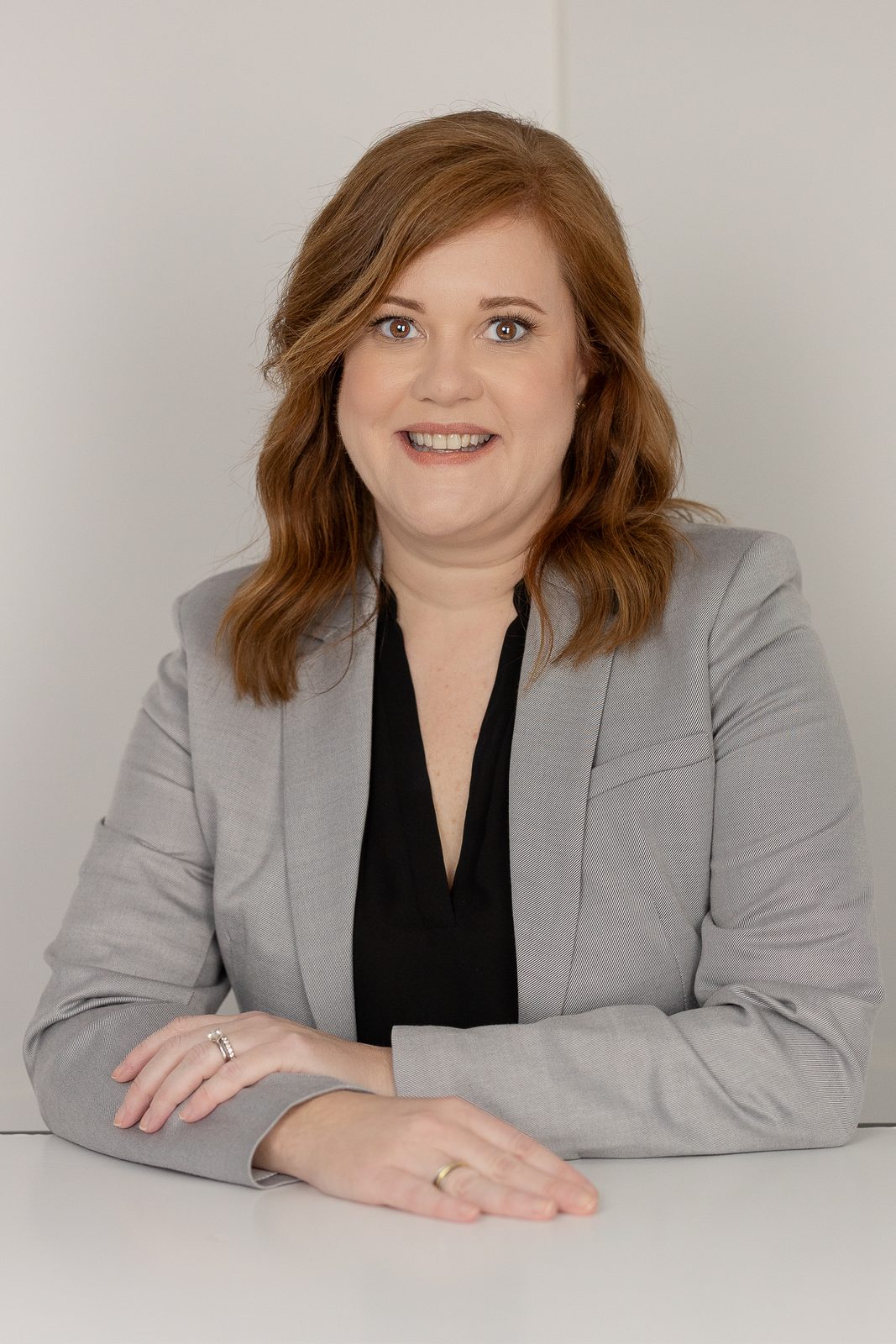 Business headshot in grey blazer