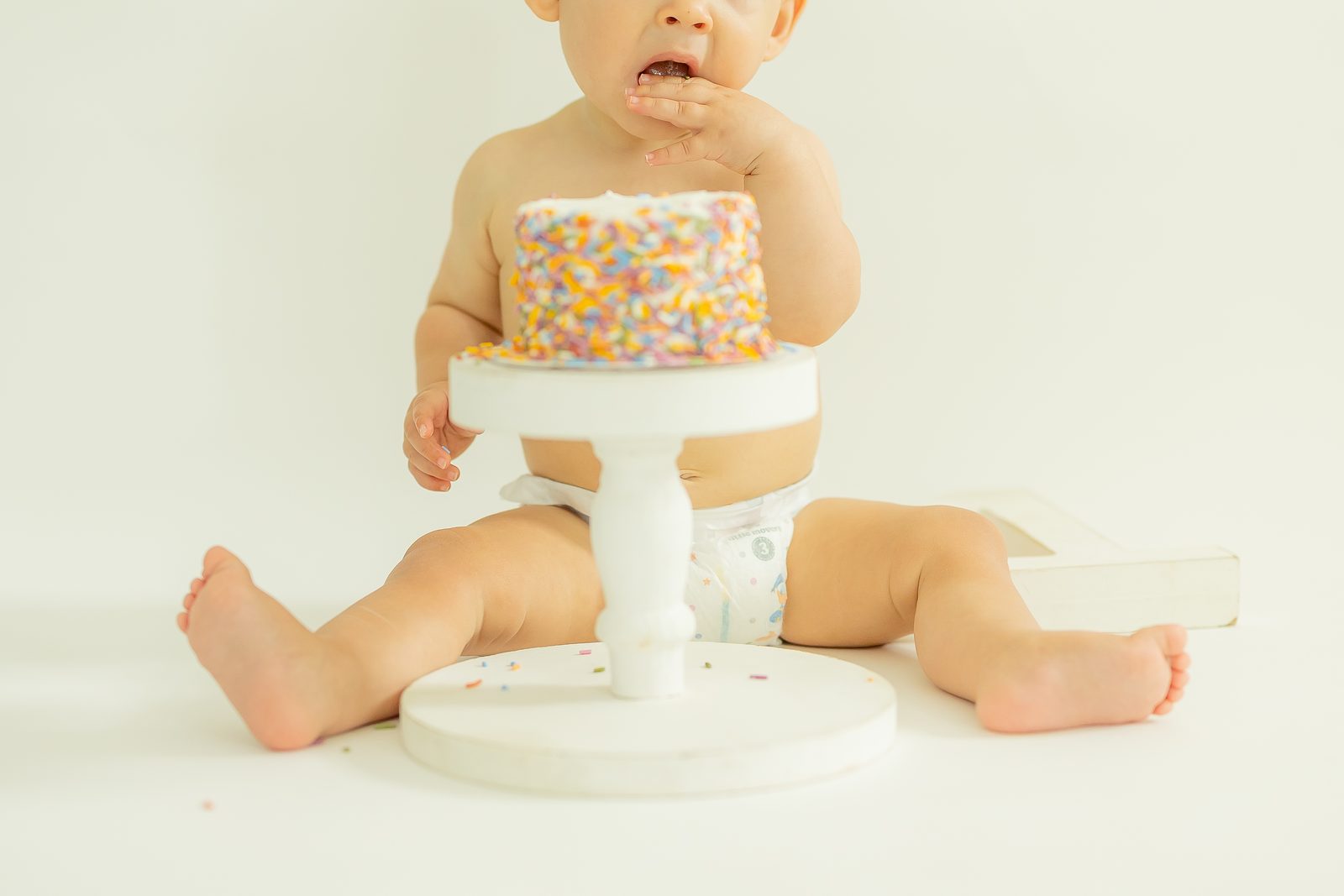 First birthday sprinkle cake smash close-up